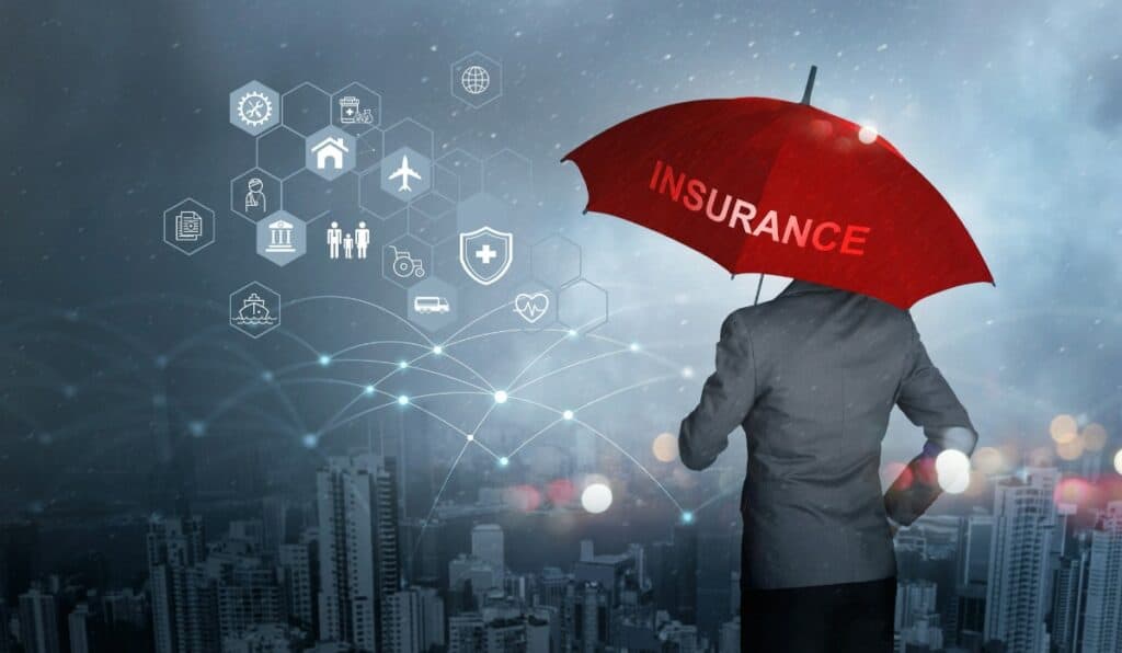 insurance concept businessman holding red umbrella